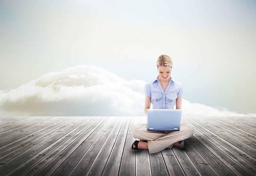 Person Working on Laptop Sitting on a Deck